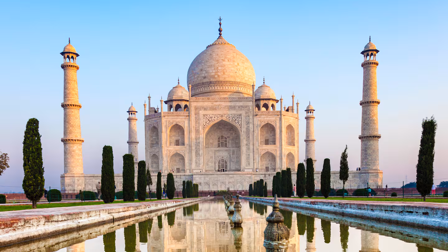 Refined Indian architecture reflected in still water at dawn