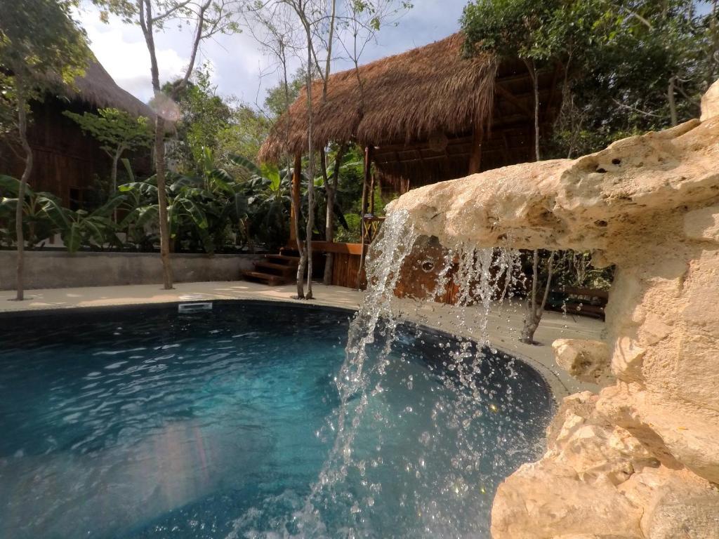 Quiet cenote-style pool and jungle palapa at Tulum Nueve