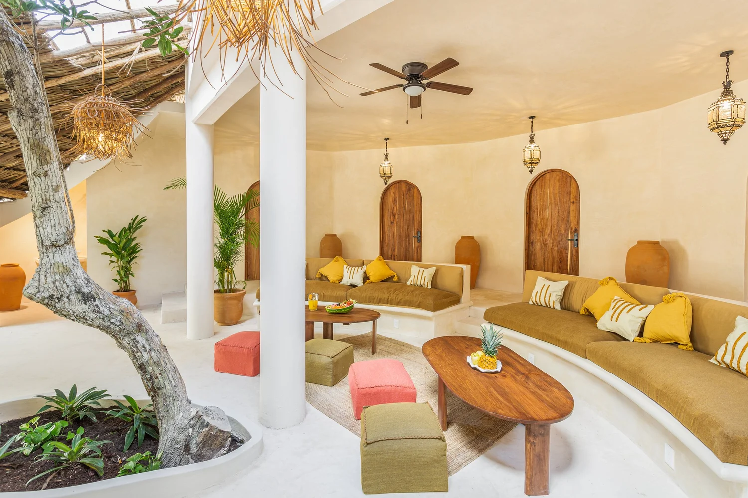 Bright open-air living sala at DORA Jungle Retreat with natural wood, woven details and tropical plants